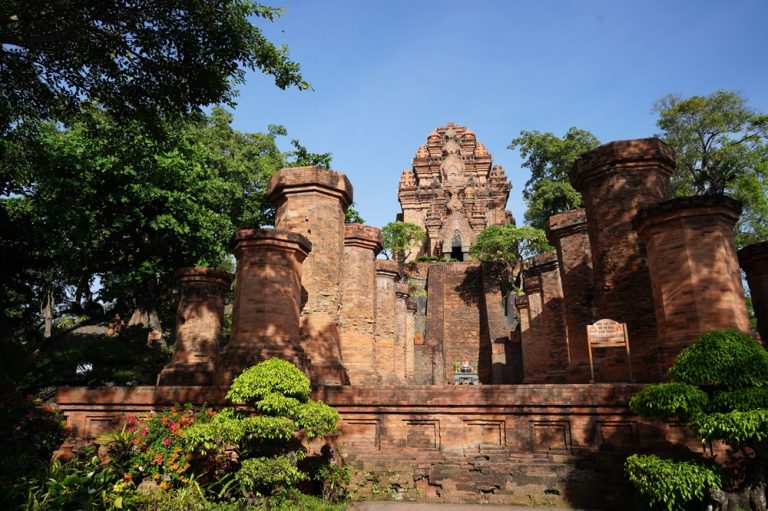 Ancient brick towers of Po Nagar Cham Towers surrounded by trees in Nha Trang, Vietnam