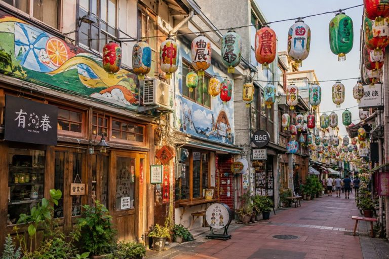Colourful lanterns hanging above the decorated historic houses of Shennong Street in Tainan