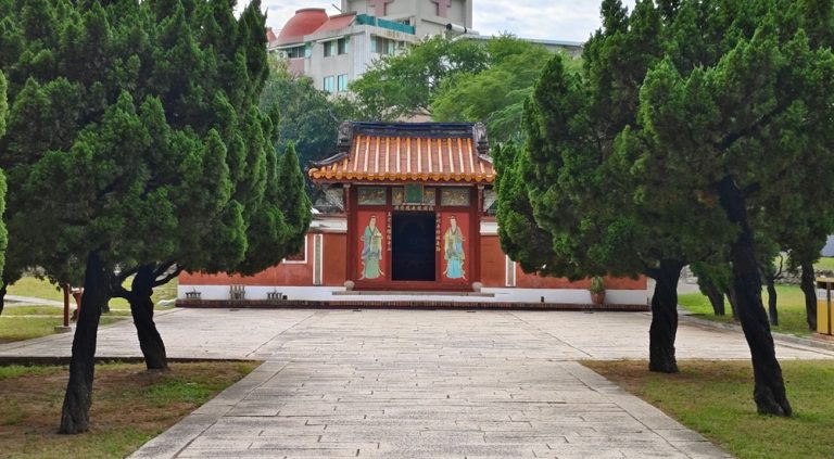 Traditional red temple building surrounded by trees at Tainan Confucius Temple Caption Description