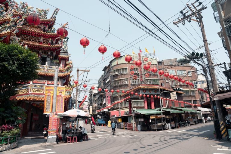 Traditional temple and red lanterns lining a local street in Tainan