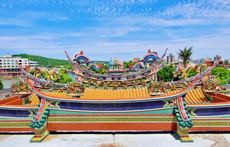 Colourful traditional temple rooftops decorated with dragons and ornate sculptures in Tainan Caption Description