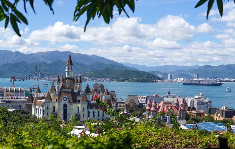 VinWonders Nha Trang with European-style buildings, cable cars, Nha Trang Bay and mountains in the background